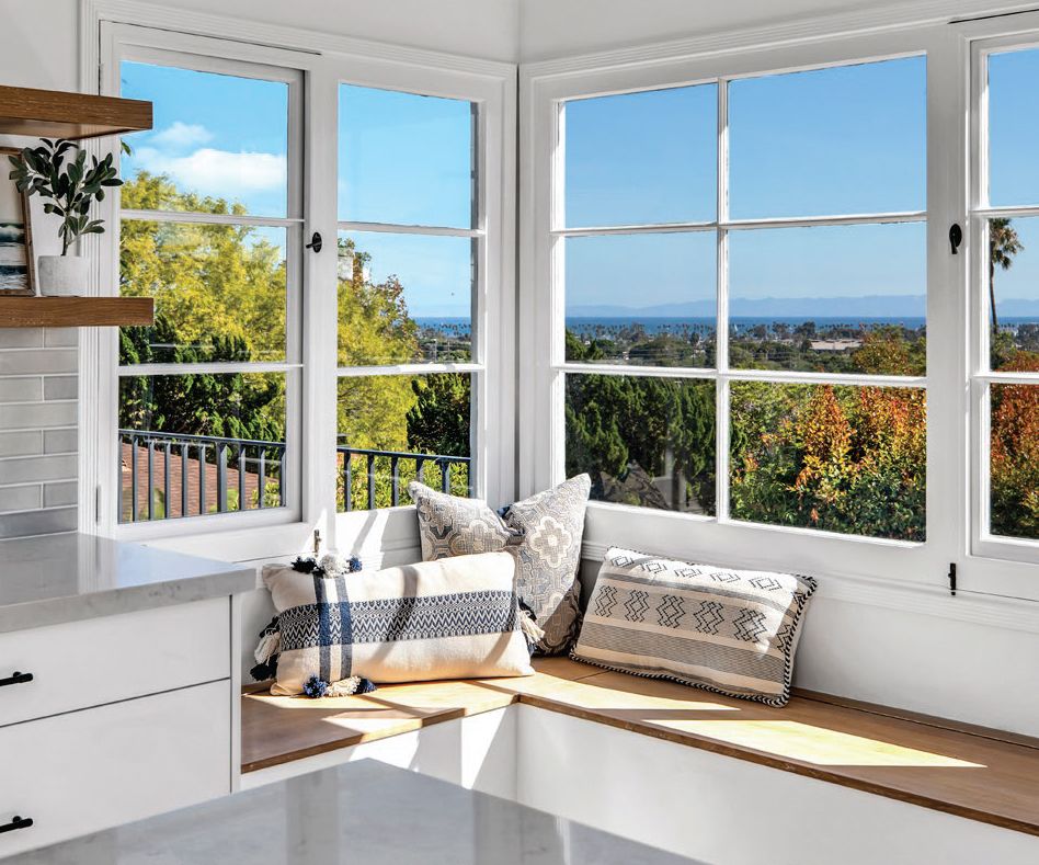 kitchen sitting nook under large windows